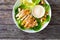 Caesar salad - fried chicken breast and vegetables on wooden table