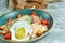 Caesar salad with fried egg. Beautiful serving dishes. Light gray background. Restaurant menu