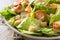 Caesar salad with lettuce,chicken and croutons on wooden table.