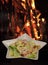 Caesar salad served in white plate in shape of star. Traditional dish in the restaurant - Caesar salad, fire on
