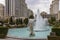 Caesars Palace Hotel, Casino and resort along the Las Vegas strip with tall lush green trees, water fountains, statues, blue sky