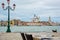 Cafe on the banks of the Venetian lagoon of the island on San Giorgio Maggiore, Piazza San Marco and the Doge`s Palace. Venice