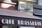 Cafe brasserie french sign text means coffee brewery on entrance restaurant in city street storefront building pub entrance