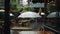 a cafe during a rainy day through a high-quality, full-frame photo of a white umbrella, creating a compelling visual