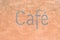 Cafe sign on stone wall background in Prague