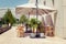 Cafe with a summer terrace. Umbrellas, tables and tropical plants