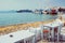 Cafe table and cruise liner in Aegean sea. Chora, Mykonos island, Greece