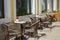 Cafe table on the street wicker chair and round table, urban restaurant bistro on the street