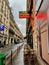 Cafe tables of le Mondial brasserie sit in the January rain on the rue Aubert, Paris, France