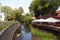 Cafe terrace and canoe boat in River Vilnele near Uzupis neighborhood, Vilnius, Lithuania.