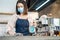 Cafe waiter wear mask, clean restaurant with sanitizer to open store. Asian attractive young female disinfecting, wiping and