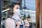 Cafe waiter wear mask, clean restaurant with sanitizer to open store. Asian attractive young woman disinfecting, wiping and