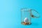 A cage with an egg inside on a blue background. The concept of slavery from birth. The concept of the future