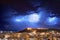 Cagliari panorama at night with lightning strikes behind the city. Lightning storm on night sky, over the city.