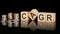 cagr - text on wooden cubes on dark backround with coins. business concept