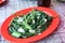 Cah Kangkung Tumis, Stir Fry Water Spinach on Red Plate