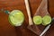 Caipirinha. A brazilian drink made with lime, cachaÃ§a, sugar and ice. wood background. slices of lemon, and a knife.