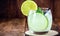 Caipirinha cocktail in glass on wooden table background. Copyspace, international caipirinha day, 13th September