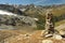 Cairn above glacial valley in Swiss Alps