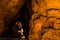 Cairn in dark tunnel through red sandstone slickrock in Moab Utah