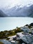 Cairn in front of lake and mountains