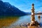 A cairn  human-made pile or stack of stones near Hallstatt lake at sunny day in Austrian Alps