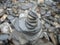 Cairn made from grey pebbles on a beach, New Zealand