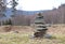 Cairn marking a hiking trail in a clearing in the forest
