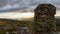 Cairn outdoors in nature during golden hour and sunset. Panoramic view.