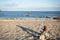 Cairn rock pile, long shadow with ocean background