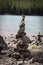 Cairn stacks built along a lake shore in summer