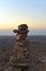 Cairn at sunrise, stones balances, pyramid of stones at sunset, concept of life balance, harmony and meditation. A pile of stones