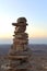 Cairn at sunrise, stones balances, pyramid of stones at sunset, concept of life balance, harmony and meditation. A pile of stones