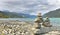 Cairn at the water`s edge in mountainous landscape of norway