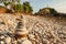 Cairn zen meditation, stones balance on stone beach, mountain light house blurred backgrounds. Lanta Island, Thailand