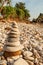 Cairn zen meditation, stones balance on stone beach, tropical trees and mountain blurred backgrounds. Lanta Island, Thailand