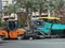 Cairo, Egypt, April 18 2023: Asphalt paver trucks and compactors, A paver (road paver finisher, asphalt finisher, road paving