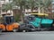 Cairo, Egypt, April 18 2023: Asphalt paver trucks and compactors, A paver (road paver finisher, asphalt finisher, road paving
