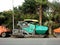 Cairo, Egypt, April 7 2023: Asphalt paver trucks and compactors, A paver (road paver finisher, asphalt finisher, road paving