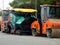 Cairo, Egypt, April 8 2023: Asphalt paver trucks and compactors, A paver (road paver finisher, asphalt finisher, road paving