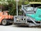 Cairo, Egypt, April 8 2023: Asphalt paver trucks and compactors, A paver (road paver finisher, asphalt finisher, road paving