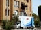 Cairo, Egypt, May 11 2023: Electric lifting winch vehicle for furniture delivery to the flat through electrical hydraulic crane