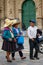 Cajamarca, Cajamarca/Peru - 16.12.2019: Peruvian locals walking on the sidewalk in front of the main city cathedral