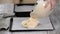 Cake batter pouring into baking dish. Home baking. Woman pour dough onto baking sheet.