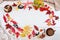 Cake, black chokeberry, red Rowan, autumn leaves and a Cup of coffee with milk on a light background. Dishes of clay. Beige Jersey