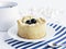 Cake with blueberry, tea cup, marshmallows and blue striped paper bag