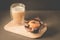 cake and cappuccino glass on a wooden tray/cake with a chocolate stuffing and cappuccino glass on a wooden tray on a dark