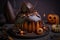 a cake with chocolate icing and decorations on a table with pumpkins and other halloween decorations around it and a jack - o -