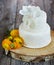 Cake covered with white fondant and buttercups.