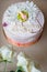 Cake with cream flowers and mastic baby figure for girl christening party.